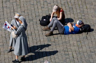 People wait a signal of smoke from the conclave, in St. Petrova Square